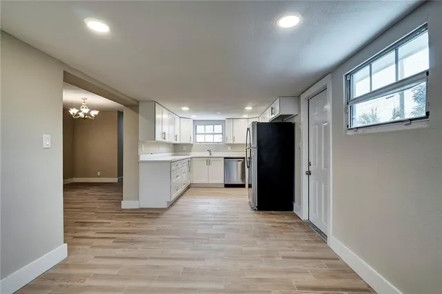 a view of a kitchen with a refrigerator and a sink