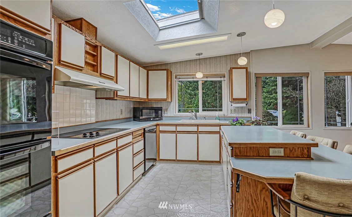 930 243rd Street Southwest Bothell, WA 98021 - Photo 2 of 37 a kitchen with stainless steel appliances granite countertop a sink and cabinets