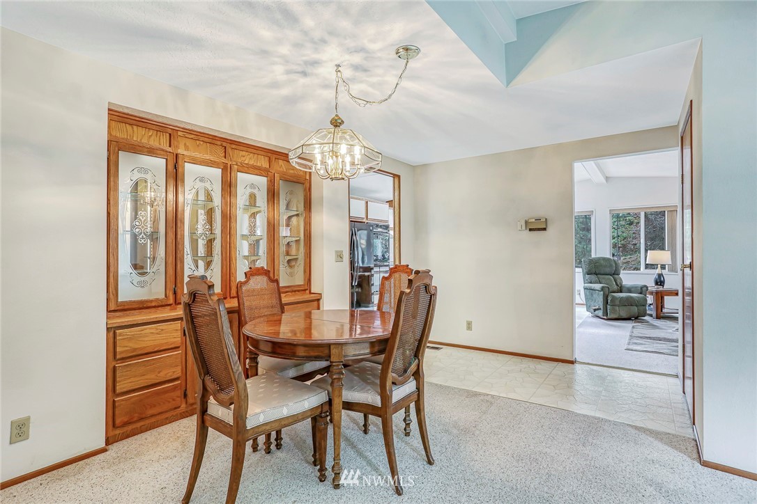 930 243rd Street Southwest Bothell, WA 98021 - Photo 13 of 37 a view of a dining room with furniture and chandelier