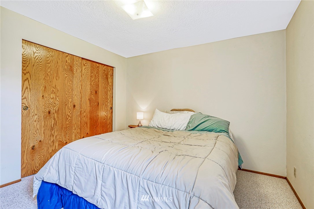 930 243rd Street Southwest Bothell, WA 98021 - Photo 25 of 37 a bedroom with a bed and a painting on the wall