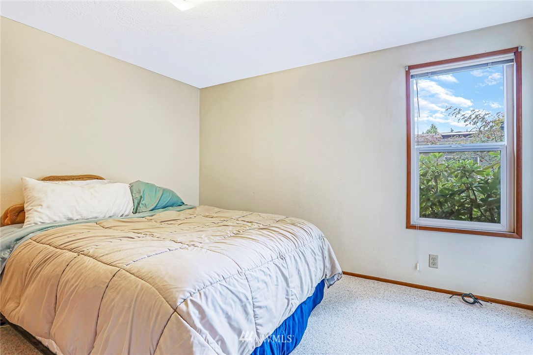 930 243rd Street Southwest Bothell, WA 98021 - Photo 26 of 37 a large bed sitting in a bedroom next to a window