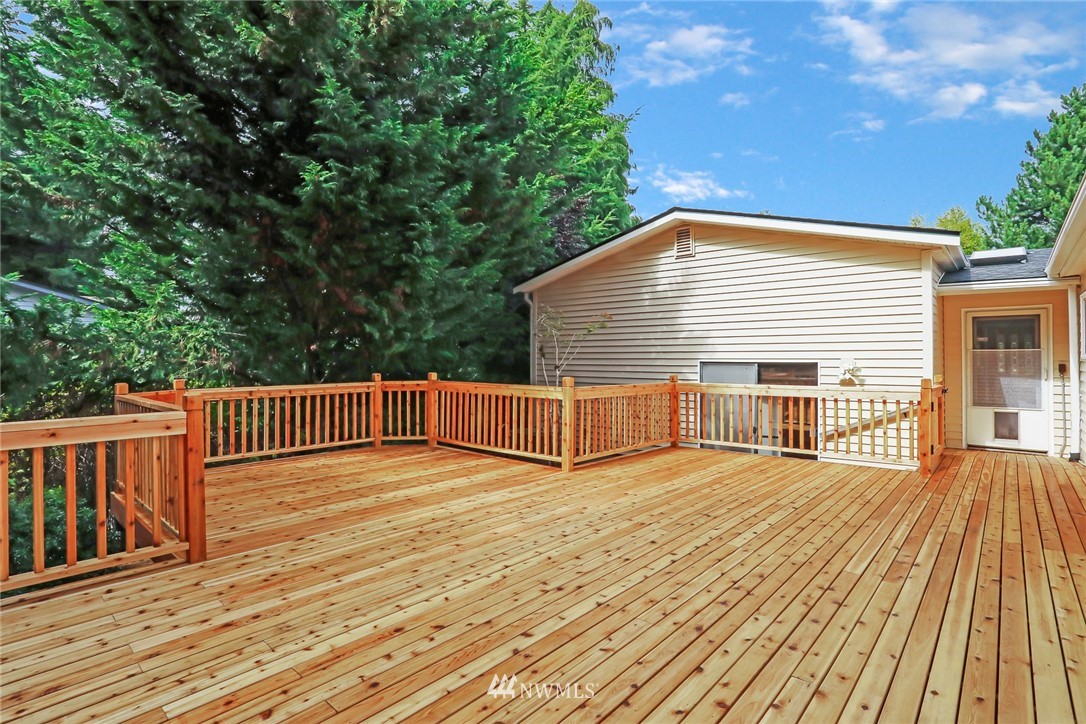 930 243rd Street Southwest Bothell, WA 98021 - Photo 34 of 37 a view of deck with wooden floor and fence next to a yard