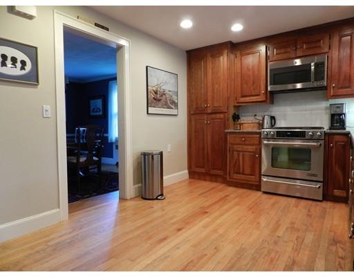 10 Mercer Road Needham, MA 02494 - Photo 4 of 22 a kitchen with stainless steel appliances granite countertop a refrigerator a stove top oven and wooden floor