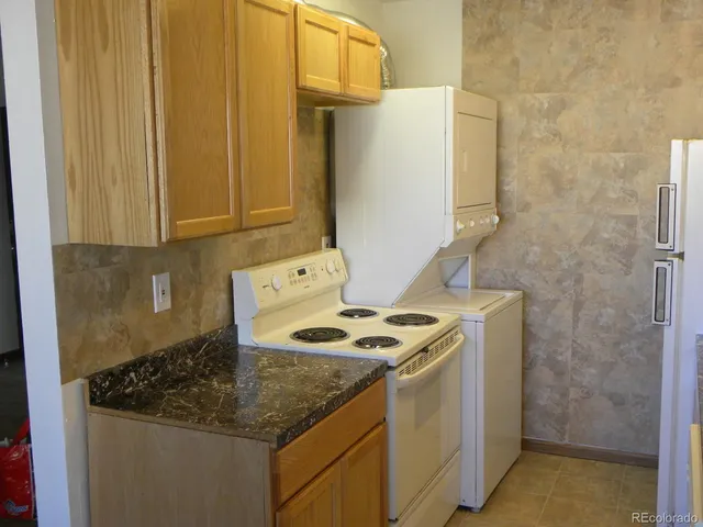 a kitchen with a sink a stove and a refrigerator