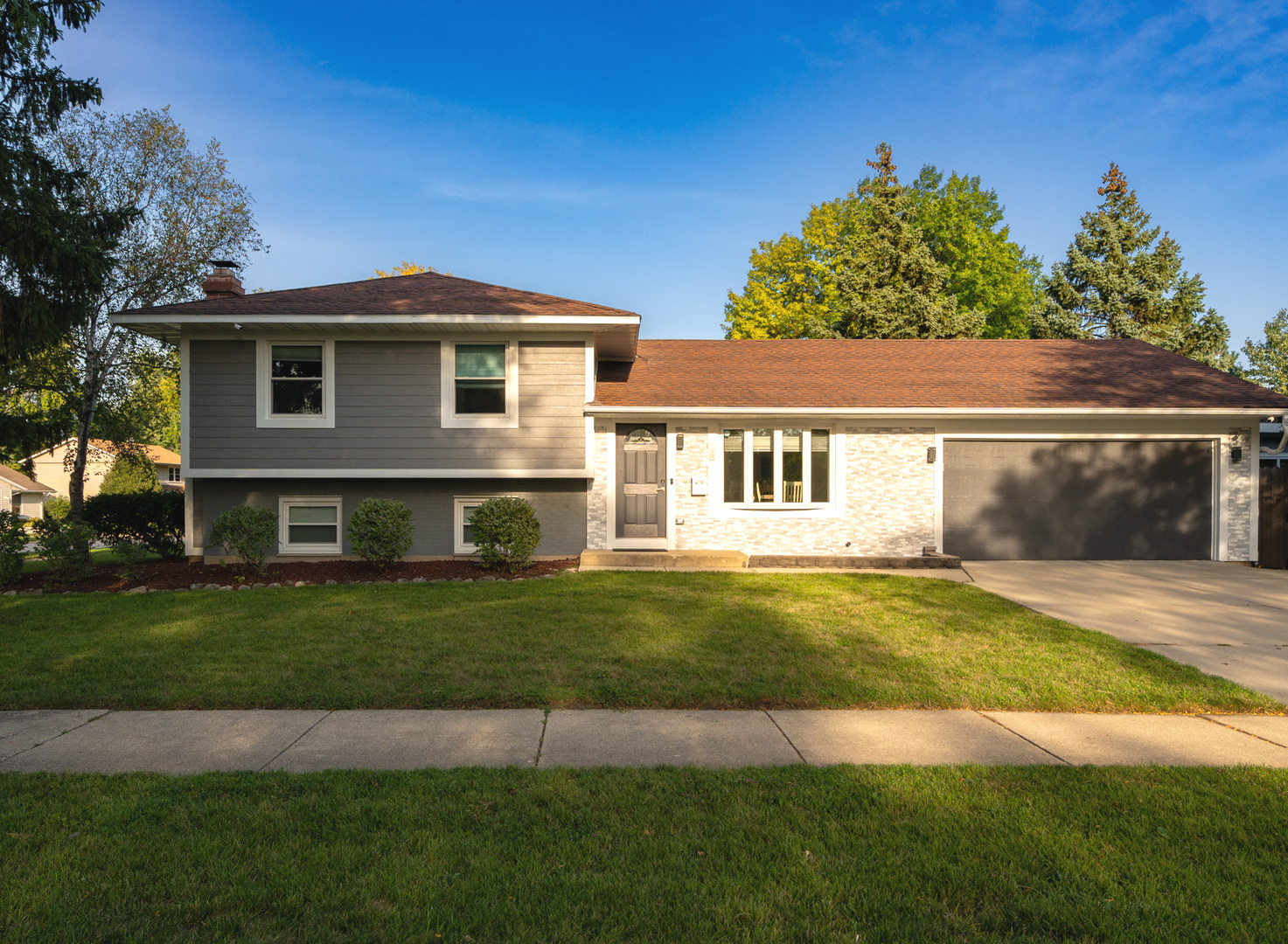 909 Springfield Drive Roselle, IL 60172 - Photo 1 of 42 a front view of a house with a garden