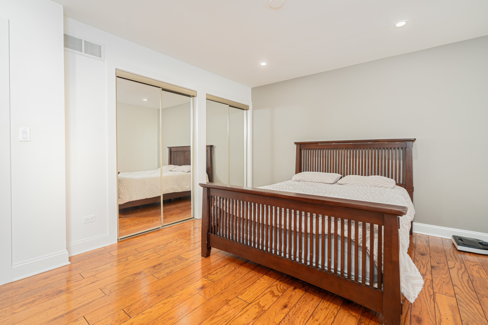 909 Springfield Drive Roselle, IL 60172 - Photo 15 of 42 a bedroom with a bed and wooden floor
