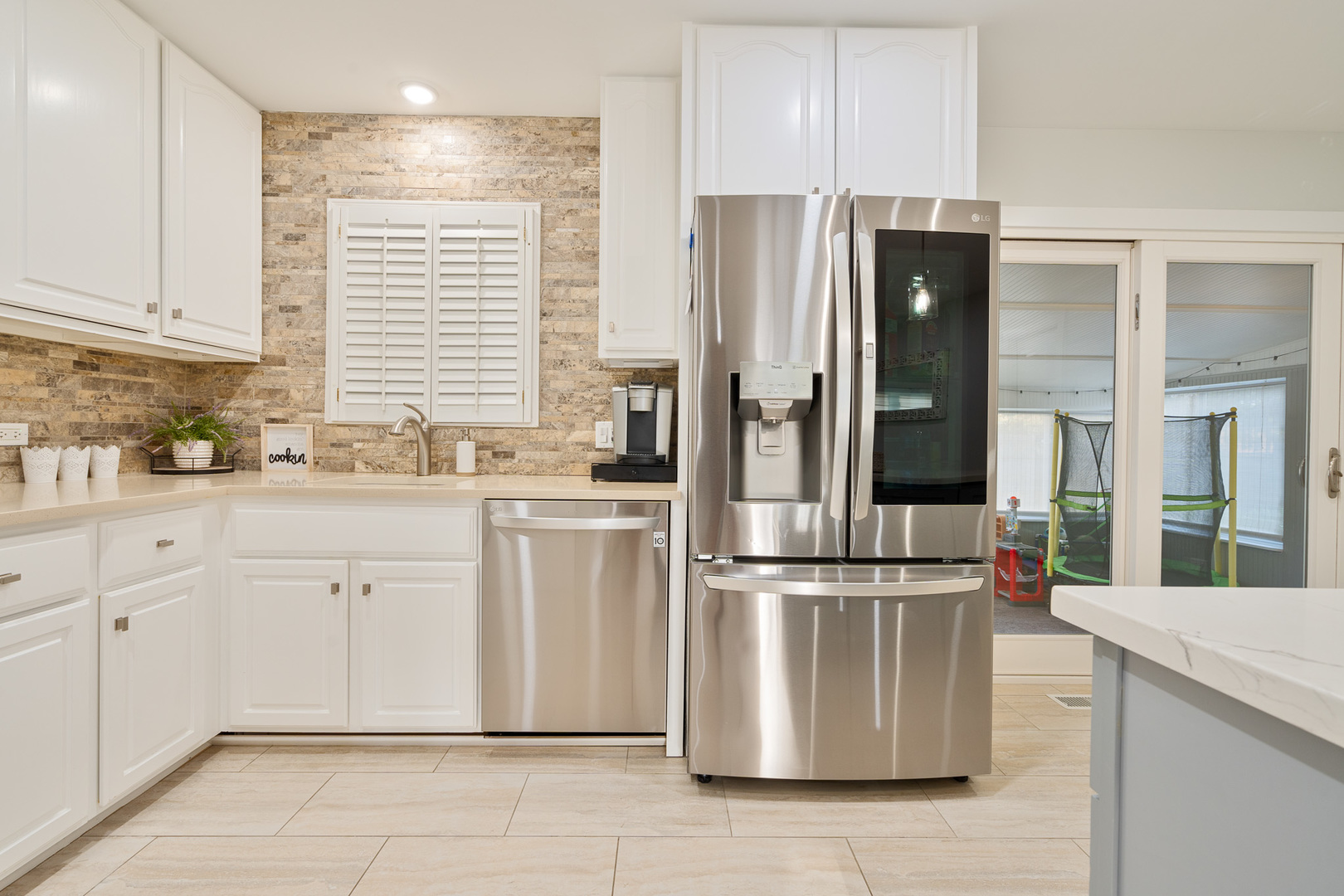 909 Springfield Drive Roselle, IL 60172 - Photo 9 of 42 a kitchen with white cabinets and white appliances