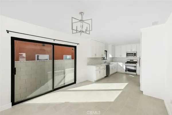 a kitchen with a refrigerator a sink and cabinets