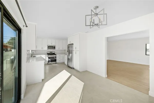 a view of a kitchen with refrigerator and cabinets
