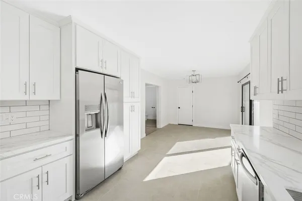 a view of a kitchen with a sink and refrigerator
