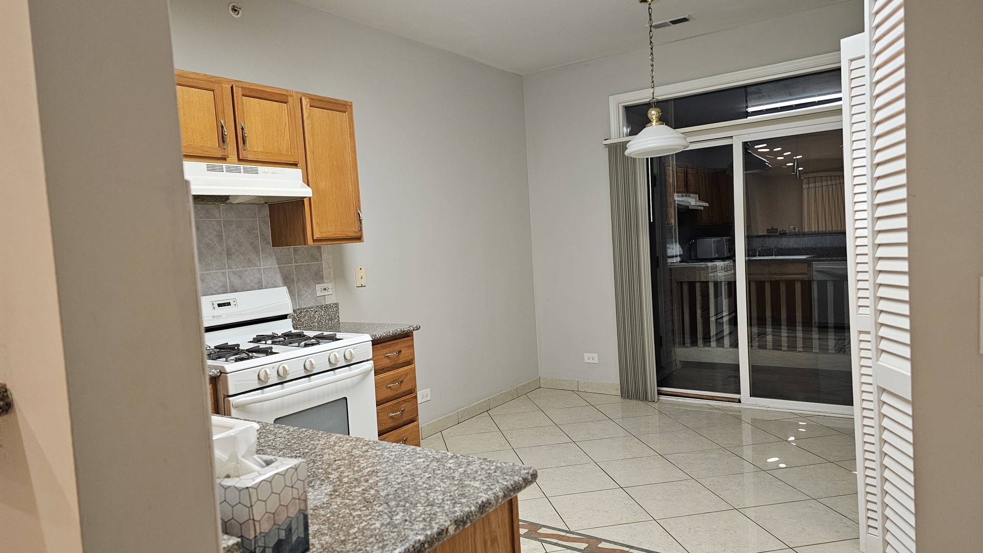 151 North Waters Edge Drive, Unit C Glendale Heights, IL 60139 - Photo 11 of 12 a kitchen with a stove and a cabinets
