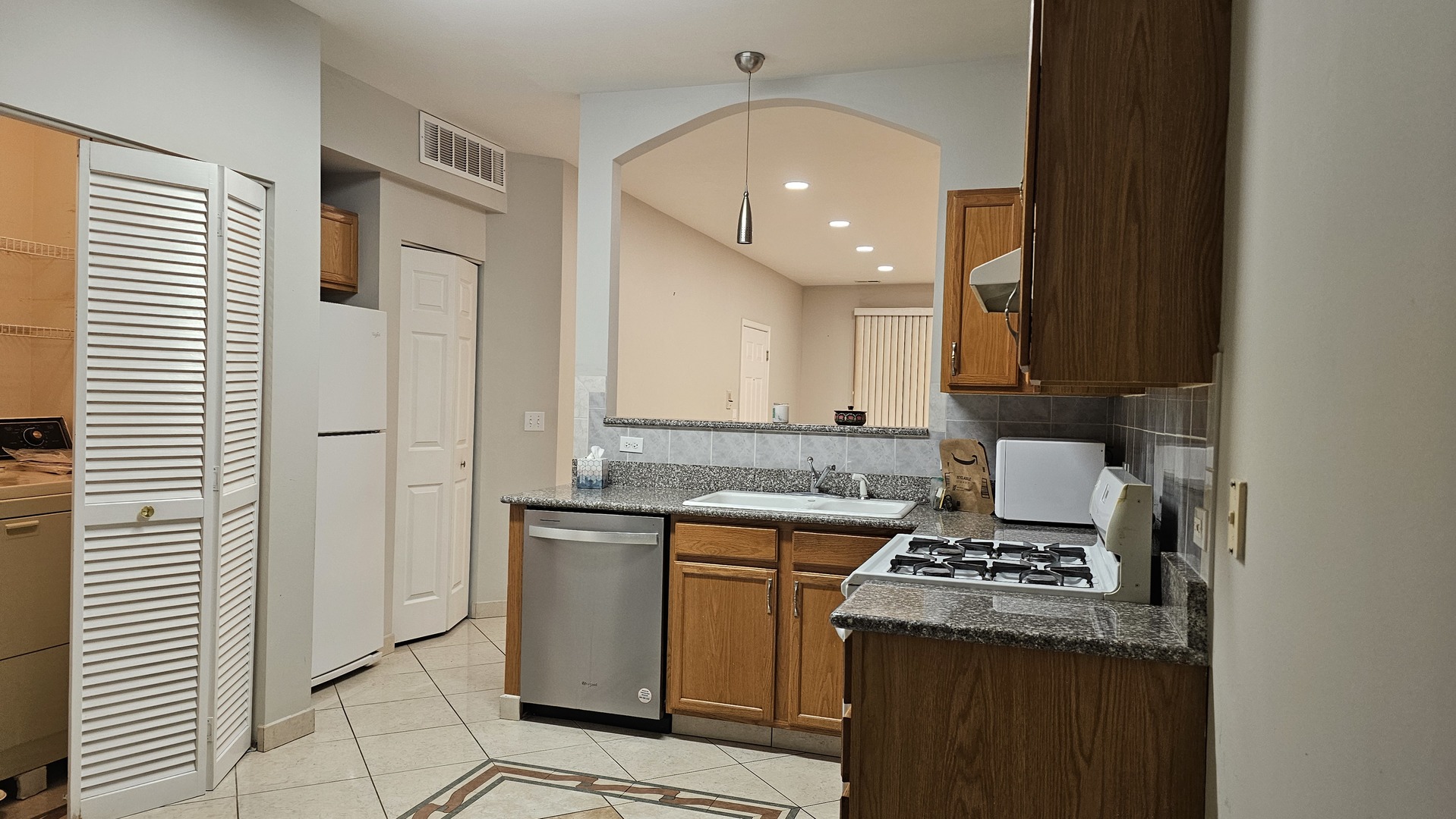 151 North Waters Edge Drive, Unit C Glendale Heights, IL 60139 - Photo 12 of 12 a kitchen with a sink stove and cabinets