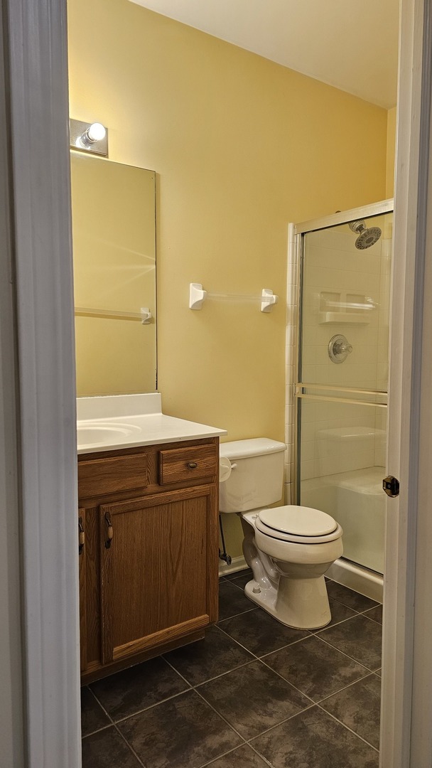 151 North Waters Edge Drive, Unit C Glendale Heights, IL 60139 - Photo 6 of 12 a bathroom with a sink a toilet and shower