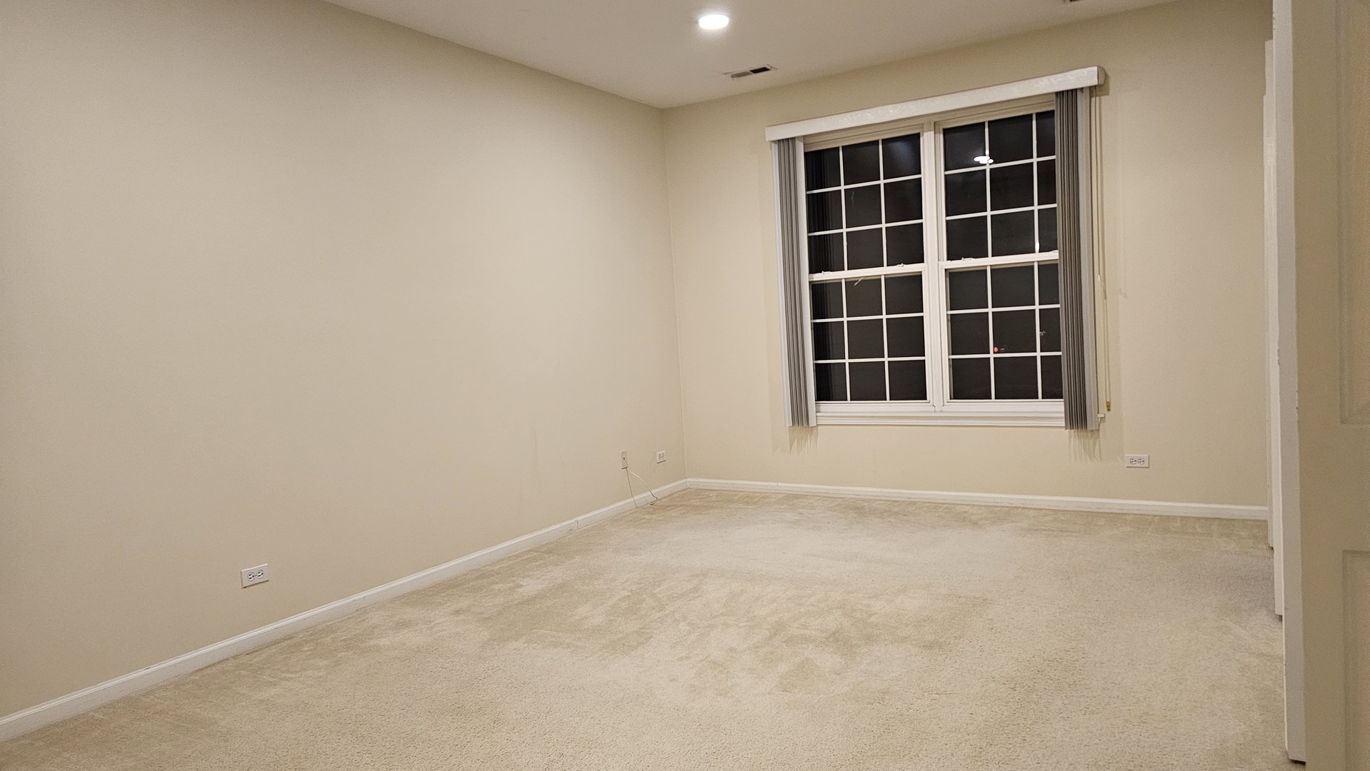 151 North Waters Edge Drive, Unit C Glendale Heights, IL 60139 - Photo 7 of 12 a view of an empty room with a window