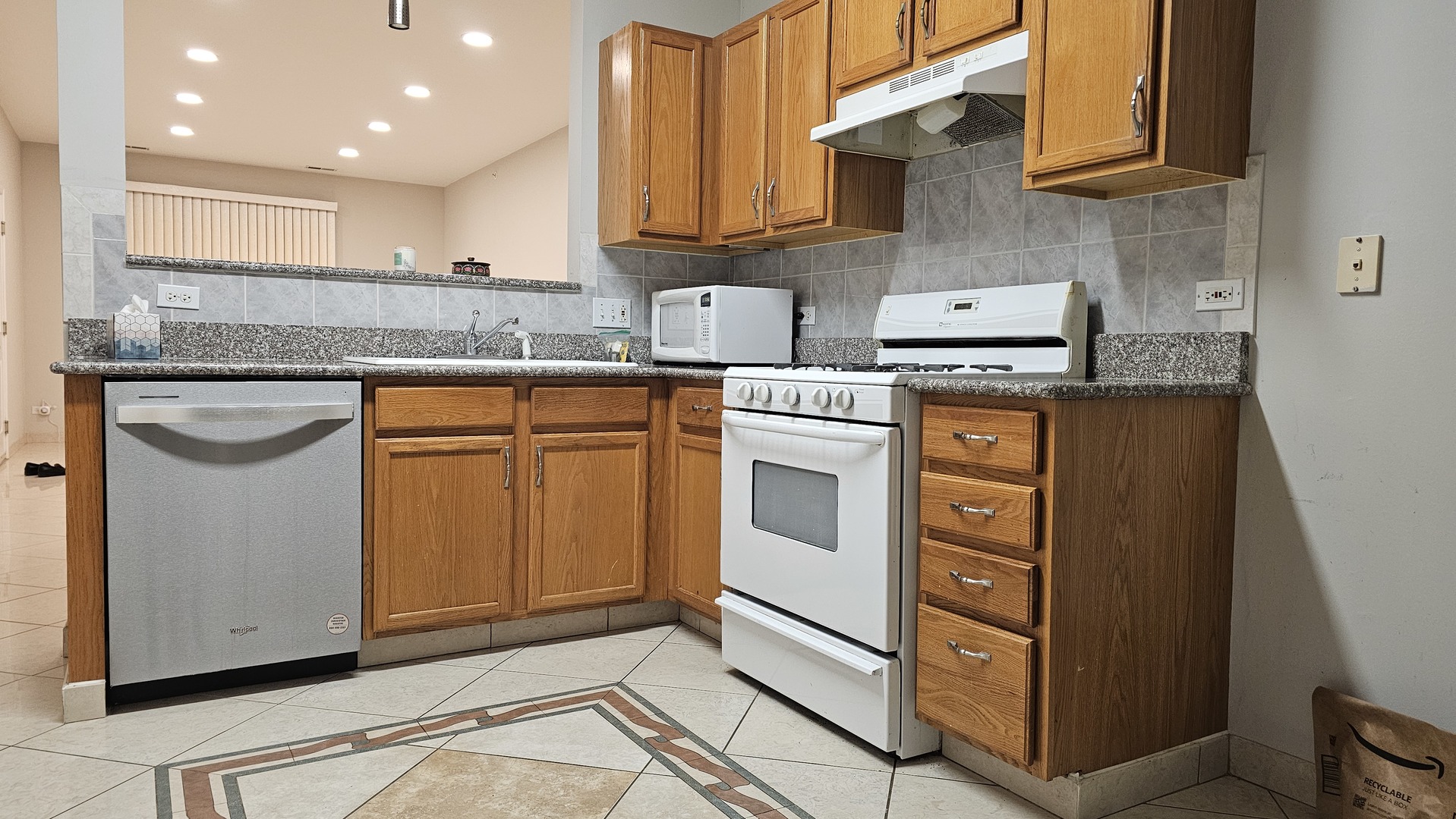 151 North Waters Edge Drive, Unit C Glendale Heights, IL 60139 - Photo 10 of 12 a kitchen with stainless steel appliances granite countertop a stove a sink and a refrigerator