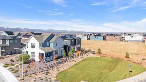 an aerial view of residential houses with outdoor space and ocean