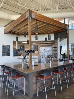 a dining room with stainless steel appliances kitchen island granite countertop a table and chairs
