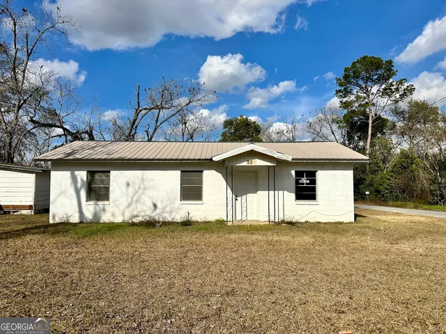 a house that has a tree in front of it