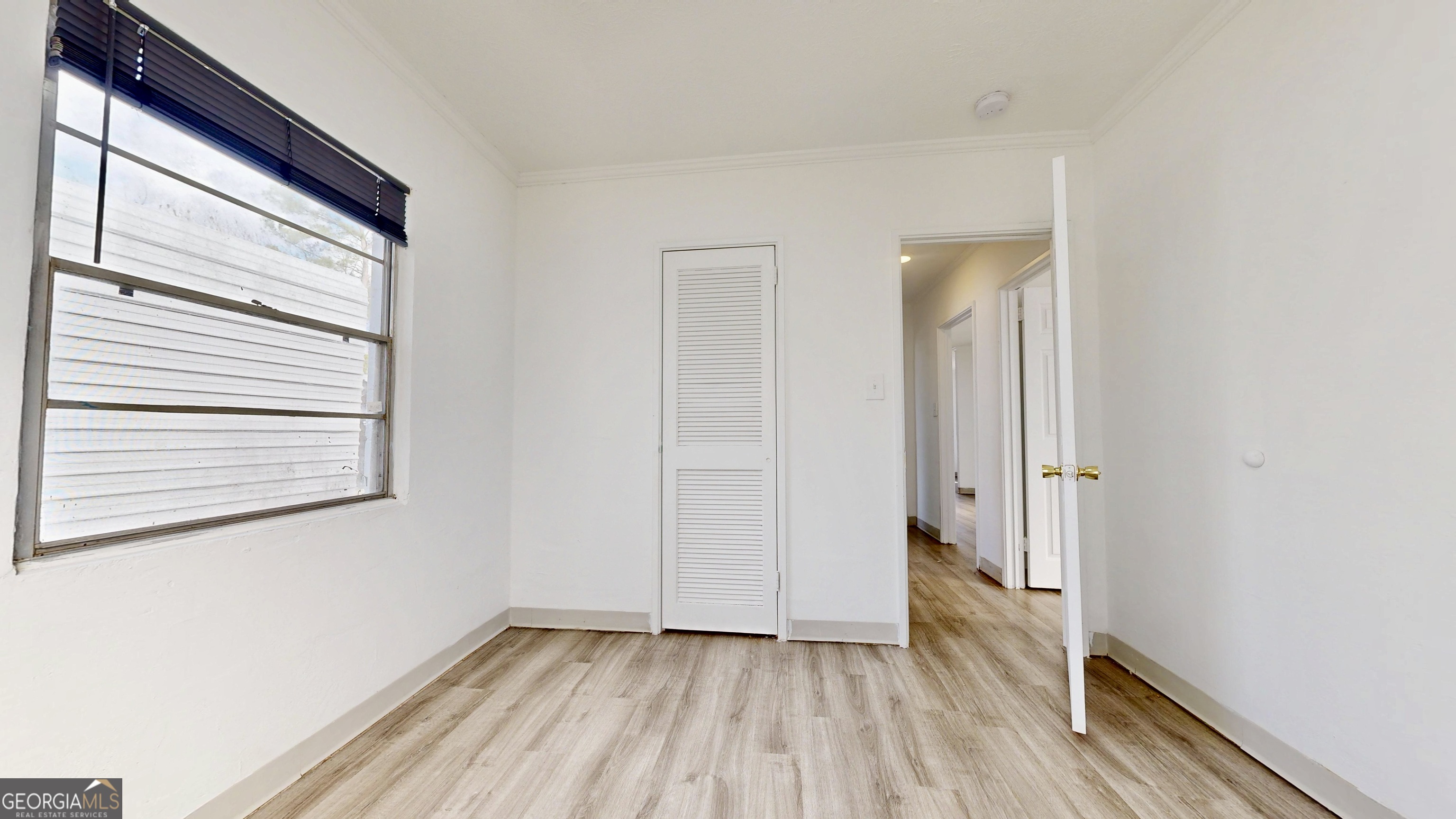 526 Ware Street Blackshear, GA 31516 - Photo 11 of 26 a view of a room with wooden floor and a window