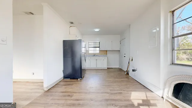 an empty room with wooden floor and a fireplace