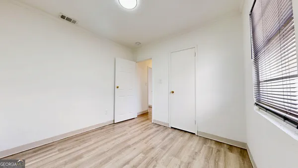 a view of an empty room and wooden floor