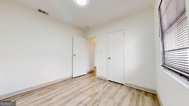 a view of an empty room and wooden floor