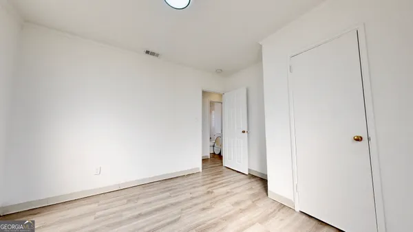 a view of a room with wooden floor