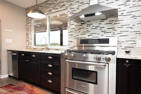 a kitchen with a stove and a sink