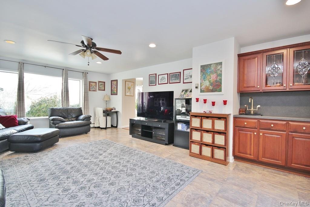 2597 Quaker Church Road Yorktown Heights, NY 10598 - Photo 12 of 37 a living room with furniture a flat screen tv and a fireplace