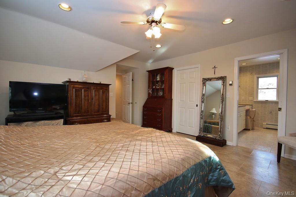 2597 Quaker Church Road Yorktown Heights, NY 10598 - Photo 19 of 37 a large bedroom with a bed and a chandelier