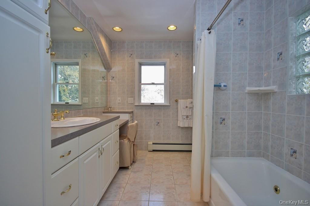 2597 Quaker Church Road Yorktown Heights, NY 10598 - Photo 20 of 37 a bathroom with a granite countertop sink a toilet and shower