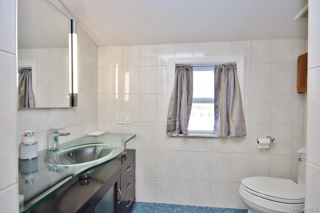 2597 Quaker Church Road Yorktown Heights, NY 10598 - Photo 23 of 37 a bathroom with a sink a toilet and a window