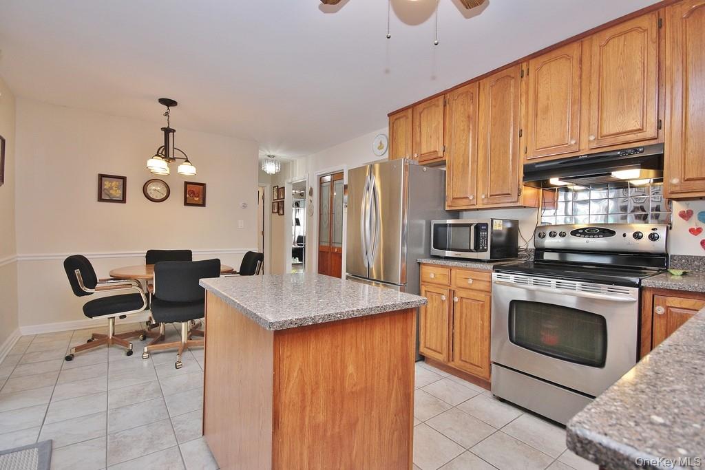 2597 Quaker Church Road Yorktown Heights, NY 10598 - Photo 3 of 37 a kitchen with stainless steel appliances granite countertop a sink stove and refrigerator