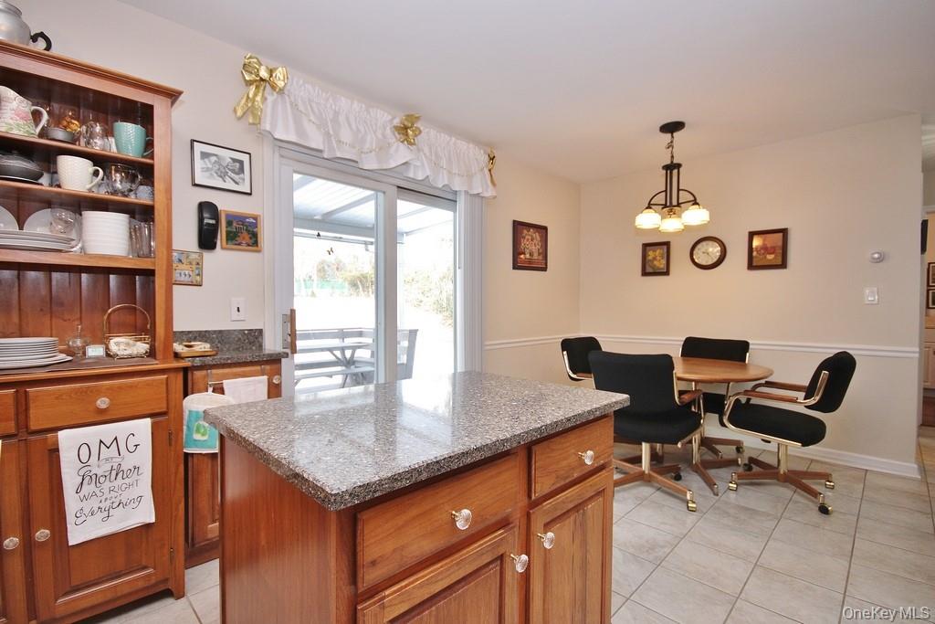 2597 Quaker Church Road Yorktown Heights, NY 10598 - Photo 4 of 37 a view of a kitchen area with furniture and chandelier