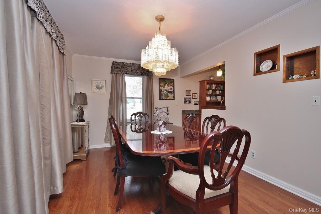 2597 Quaker Church Road Yorktown Heights, NY 10598 - Photo 6 of 37 a dining room with furniture a chandelier and wooden floor