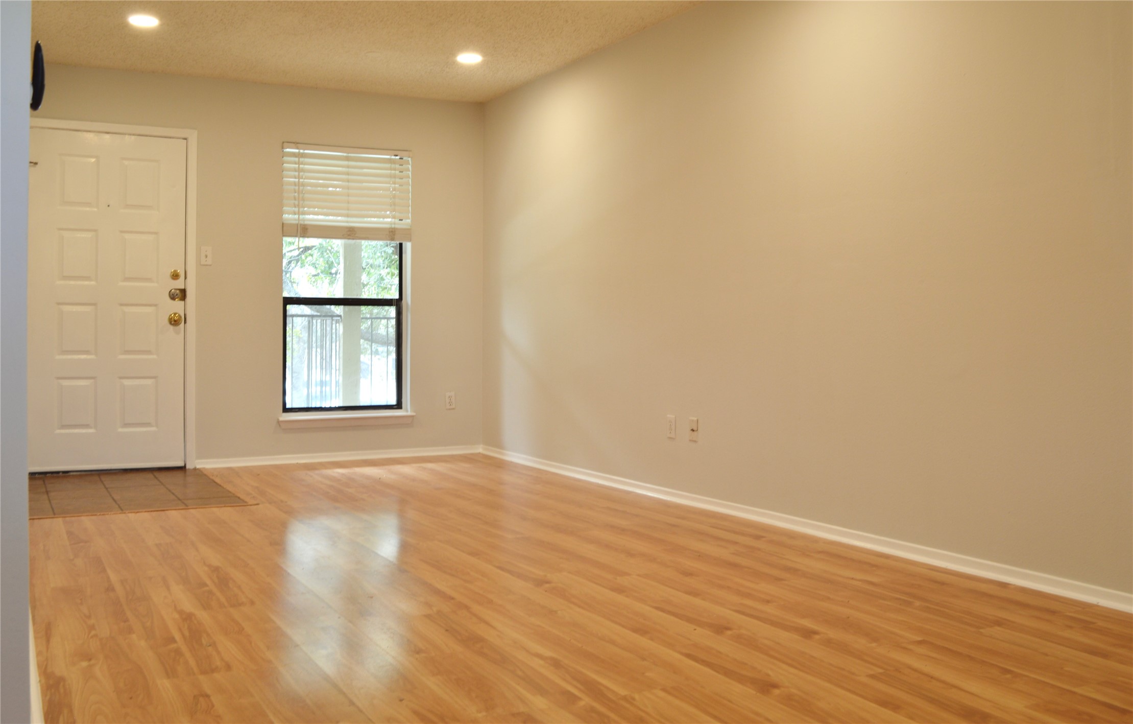 5701 Woodrow Avenue, Unit 203 Austin, TX 78756 - Photo 2 of 9 an empty room with wooden floor and windows
