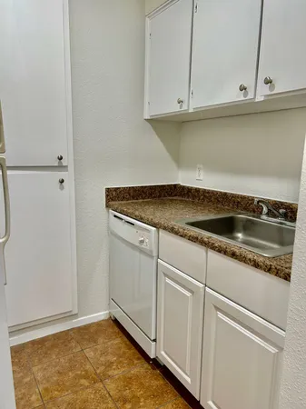 a close view of a stove top oven and cabinets