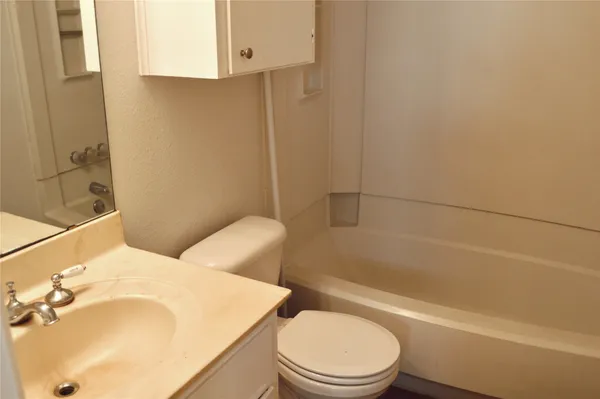 a bathroom with a sink a toilet and bathtub