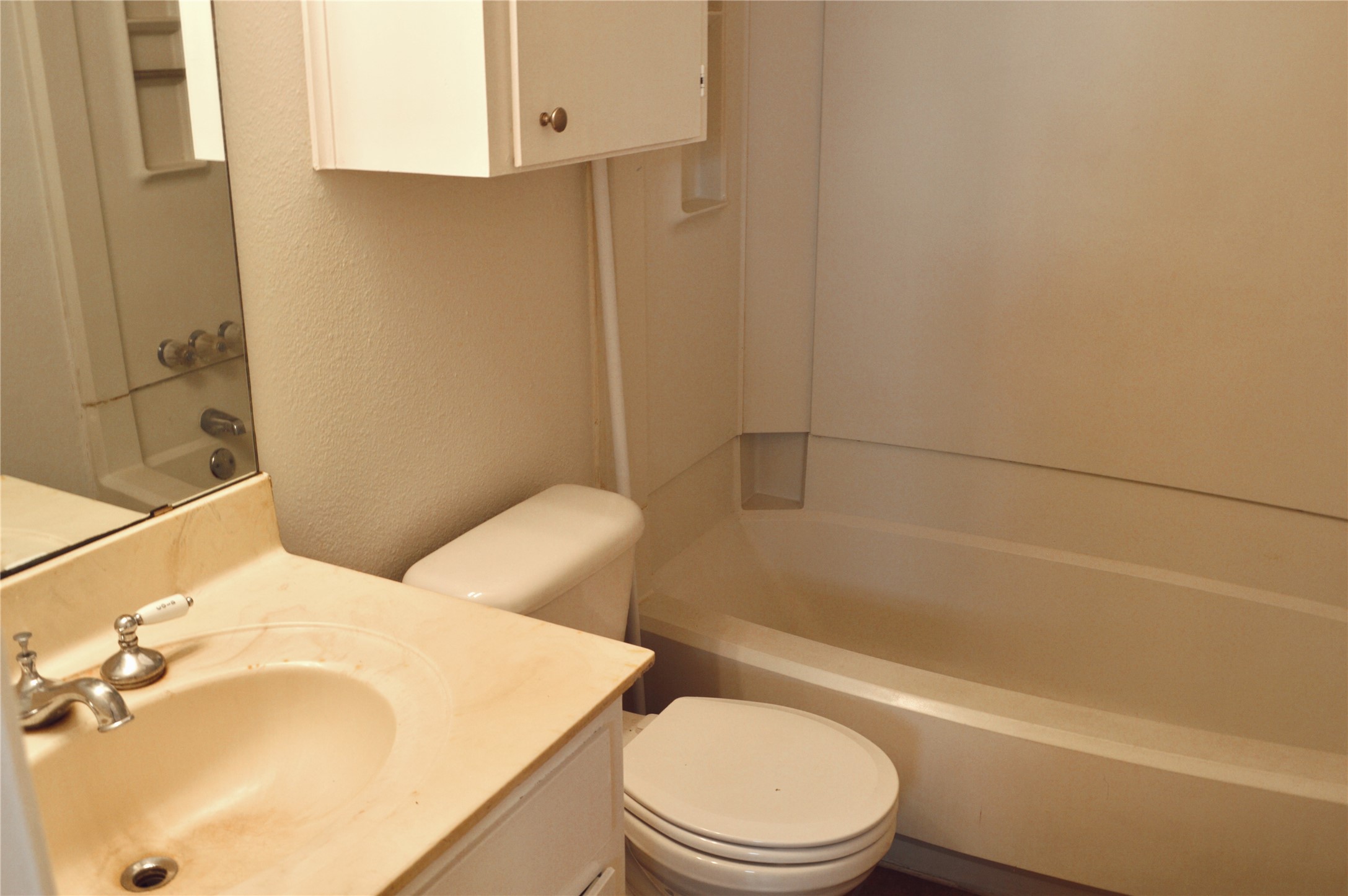 5701 Woodrow Avenue, Unit 203 Austin, TX 78756 - Photo 9 of 9 a bathroom with a sink a toilet and bathtub