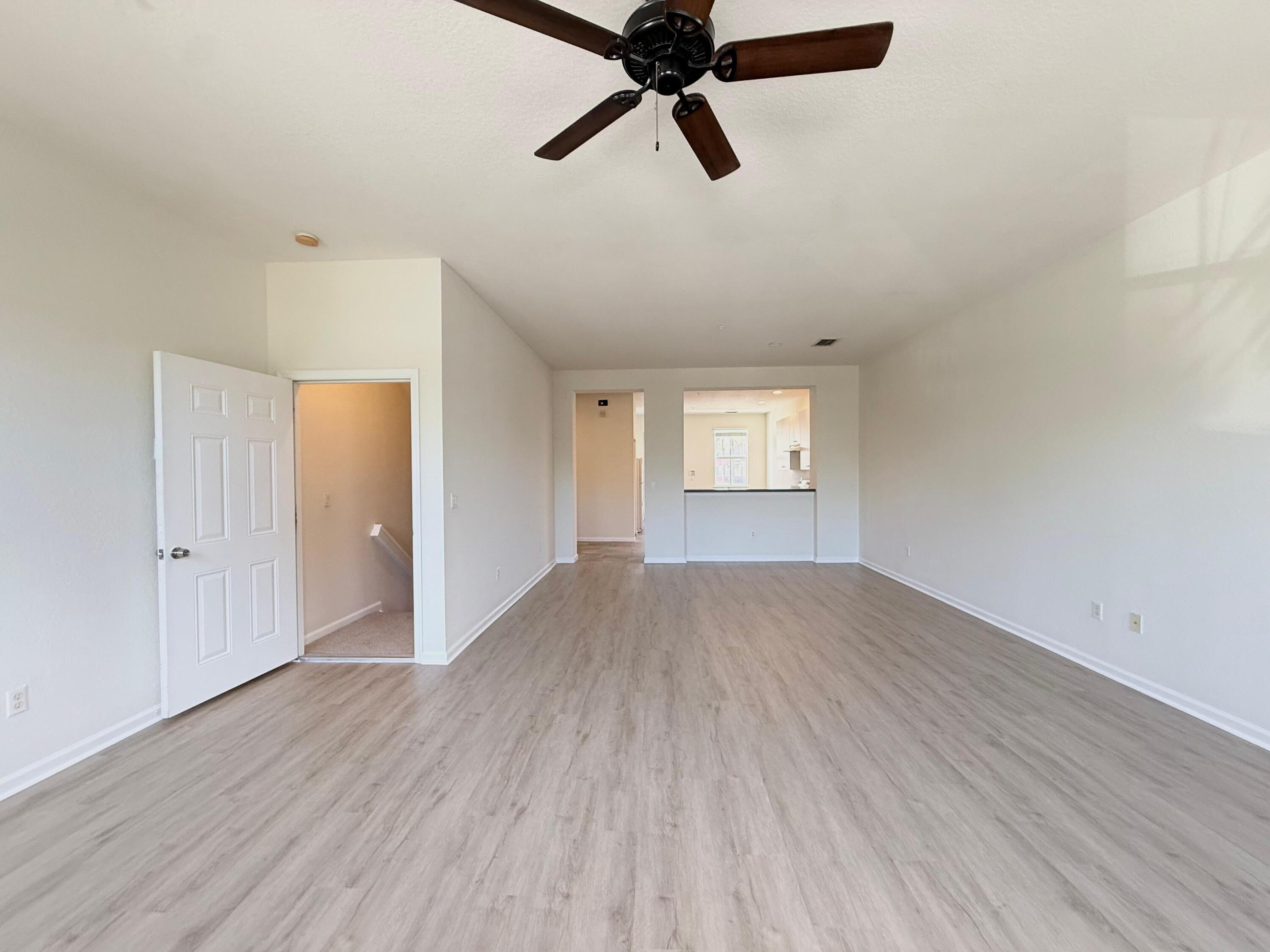 425 Greenwich Circle, Unit 206 Jupiter, FL 33458 - Photo 11 of 30 wooden floor in an empty room with a window