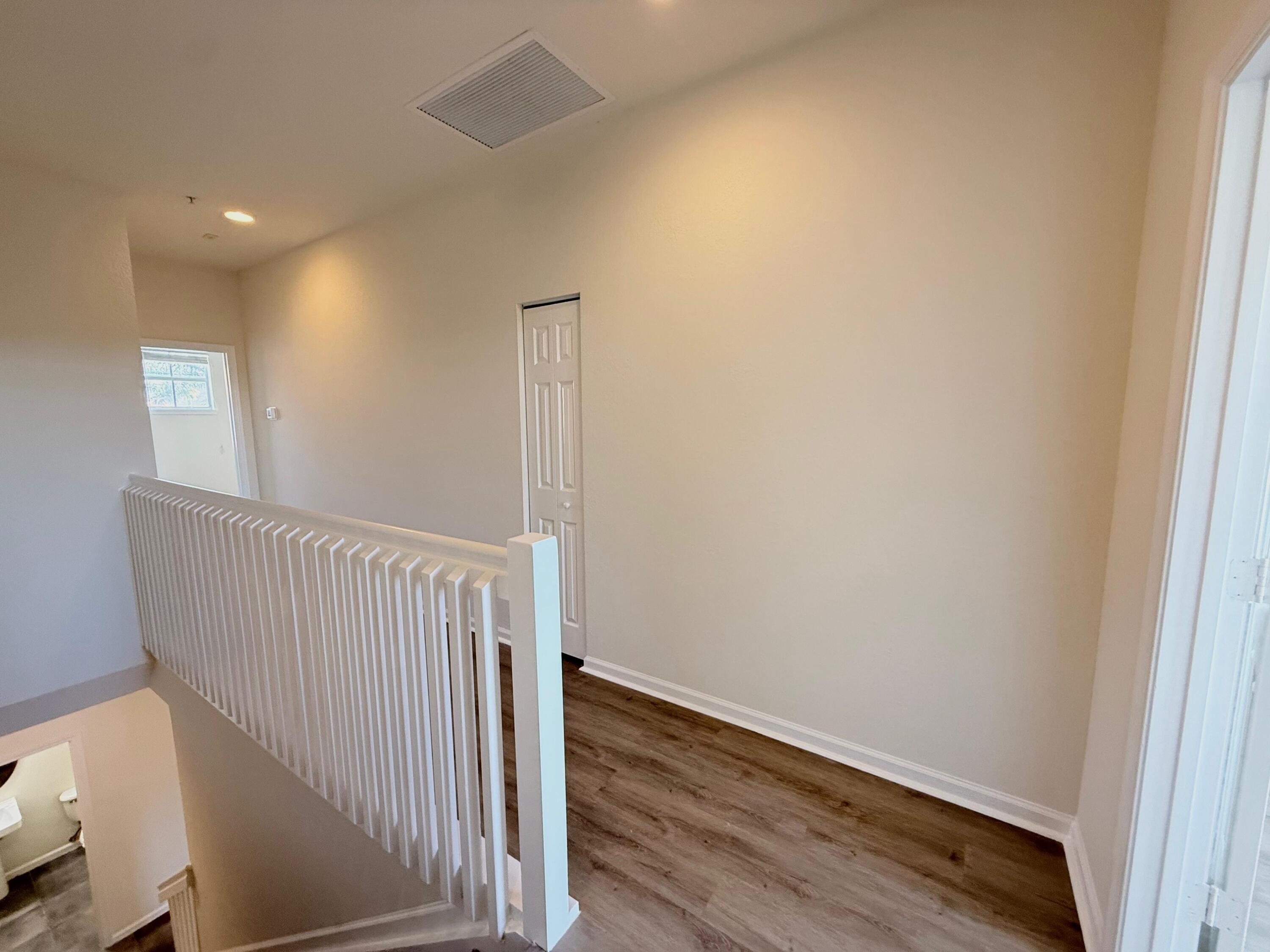 425 Greenwich Circle, Unit 206 Jupiter, FL 33458 - Photo 16 of 30 a view of a hallway with wooden floor
