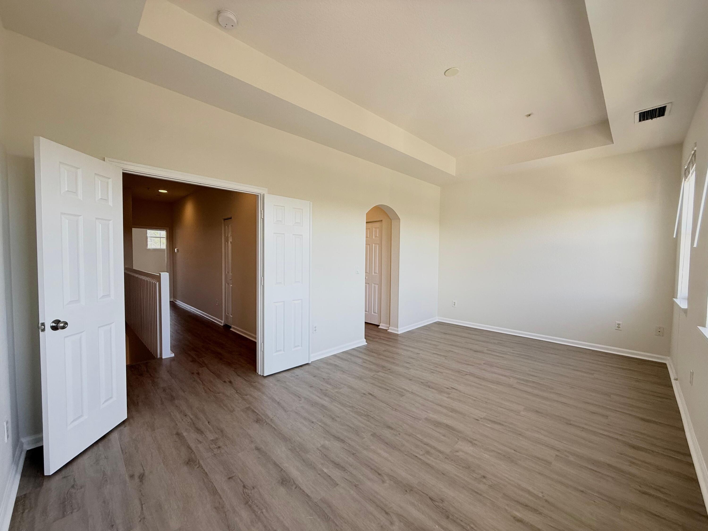 425 Greenwich Circle, Unit 206 Jupiter, FL 33458 - Photo 18 of 30 a view of an empty room with wooden floor