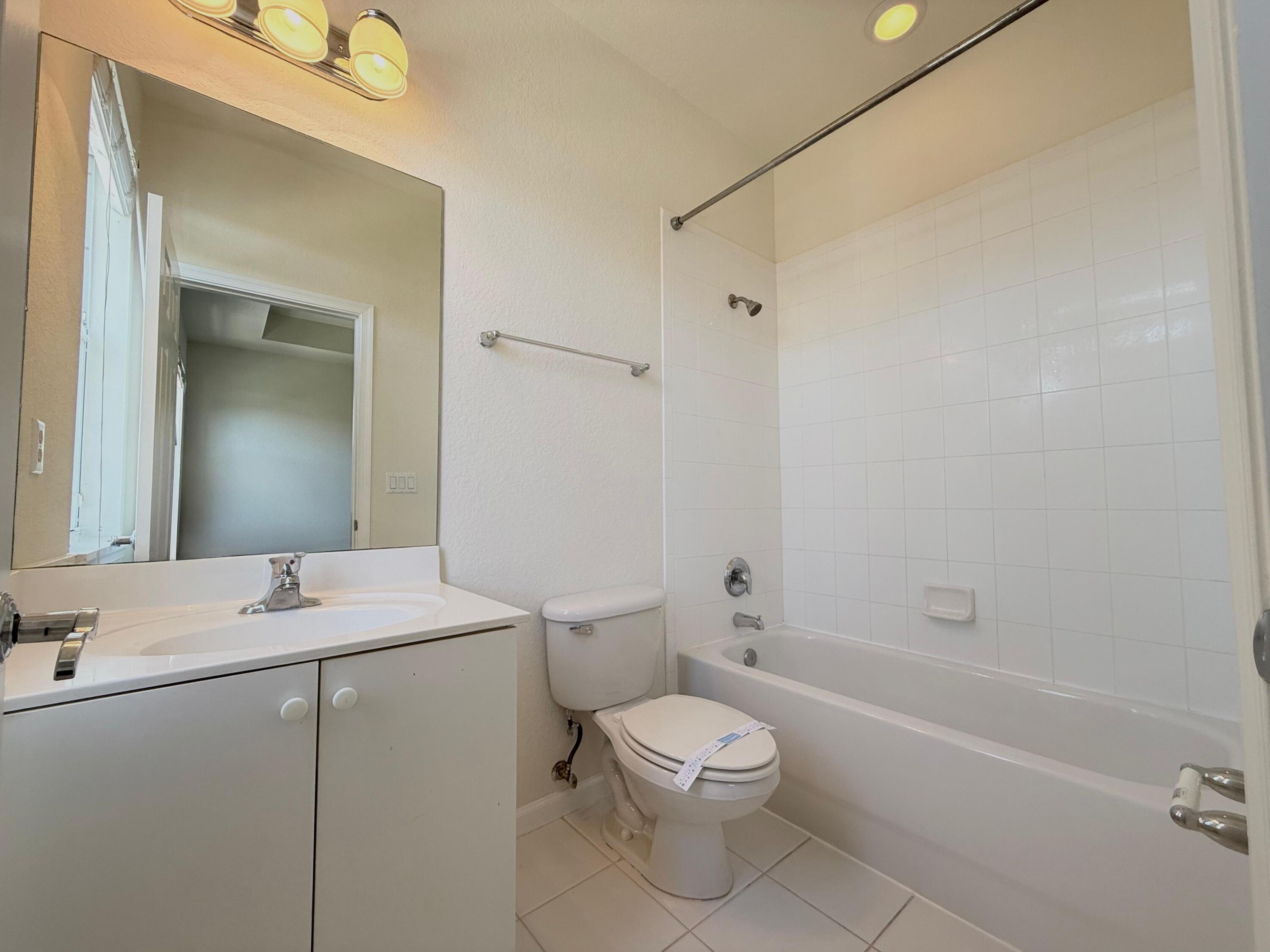 425 Greenwich Circle, Unit 206 Jupiter, FL 33458 - Photo 28 of 30 a bathroom with a sink a toilet and shower
