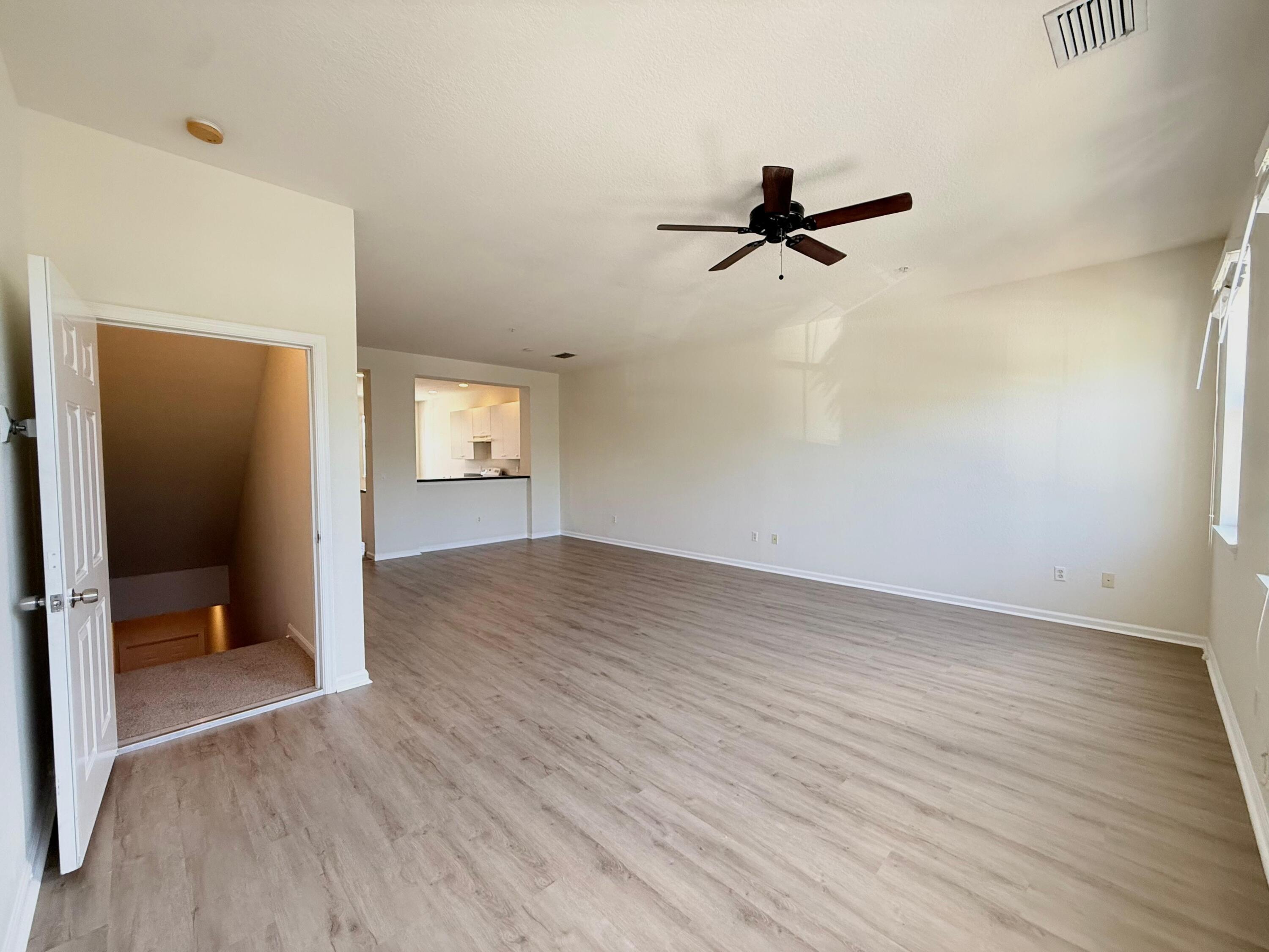 425 Greenwich Circle, Unit 206 Jupiter, FL 33458 - Photo 9 of 30 wooden floor in an empty room with a window