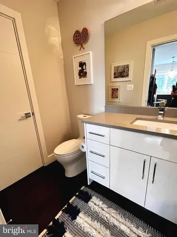 a spacious bathroom with a sink a toilet a shower and a mirror