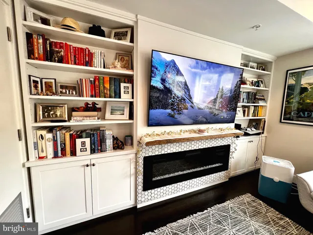a living room with bookshelf and painting on the wall