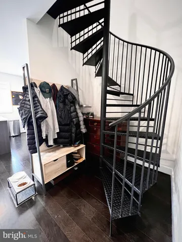 a view of gym equipment with wooden floor