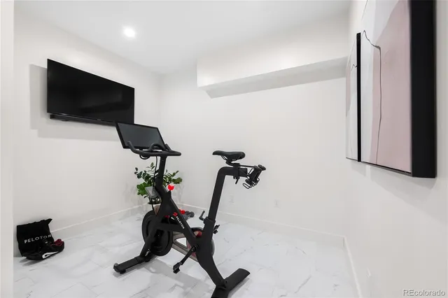 a view of a workspace with furniture and a flat screen tv