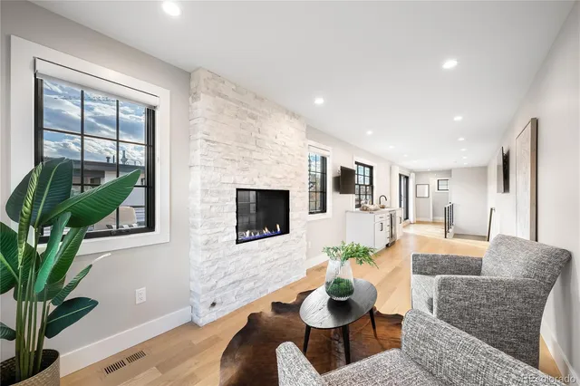 a living room with furniture potted plant and a window