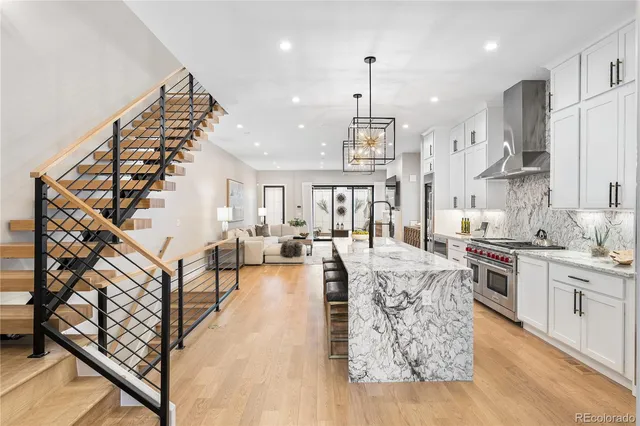 a large kitchen with lots of counter space wooden floor and appliances